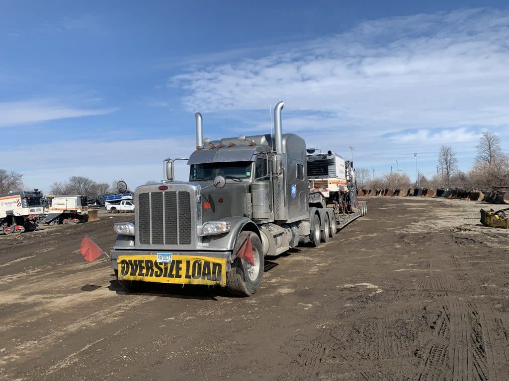 truck hauling cold milling machine